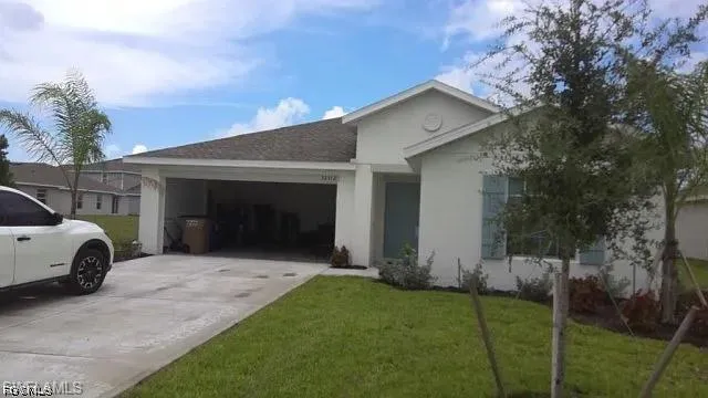 Single-story residence featuring a two-car garage, concrete driveway, and a gabled roofline