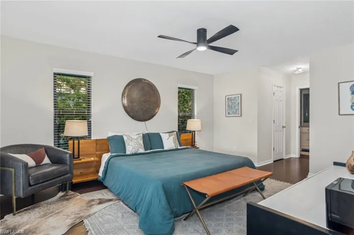 Bedroom with hardwood / wood-style flooring and ceiling fan