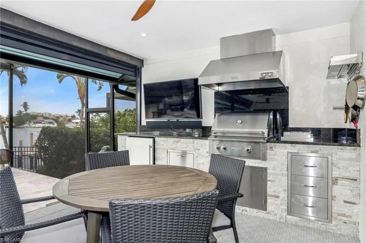 View of patio / terrace featuring area for grilling, ceiling fan, and a grill