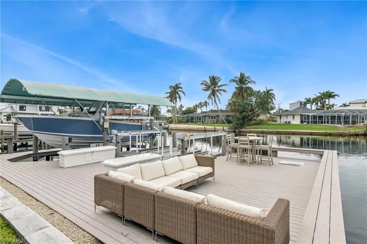 Dock area with a water view and an outdoor hangout area