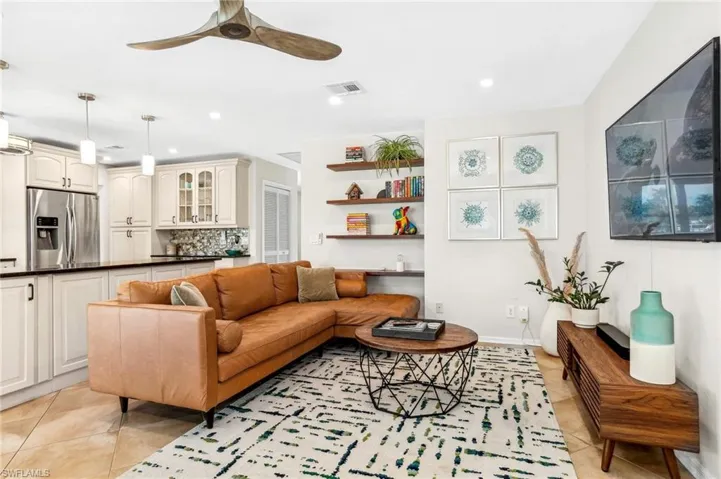 Living room featuring ceiling fan and light tile patterned flooring