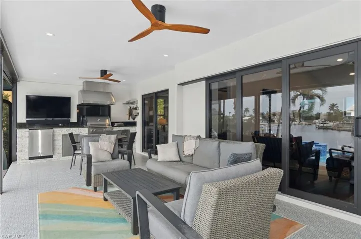 View of patio with outdoor lounge area, exterior kitchen, and grilling area