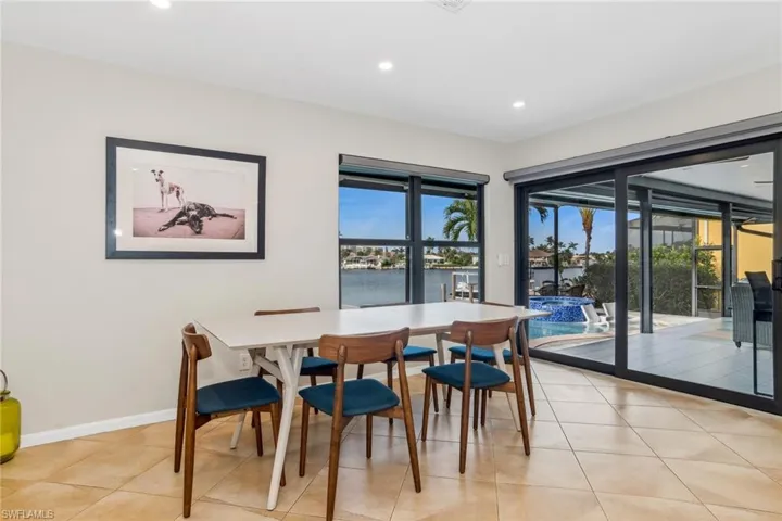 Tiled dining area featuring a water view