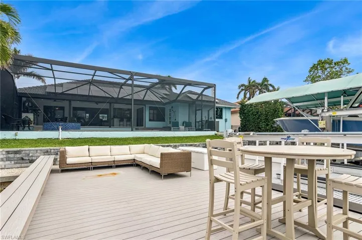 Wooden deck with a lanai and outdoor lounge area