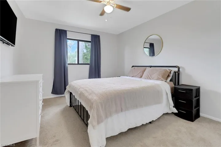 Carpeted bedroom with ceiling fan