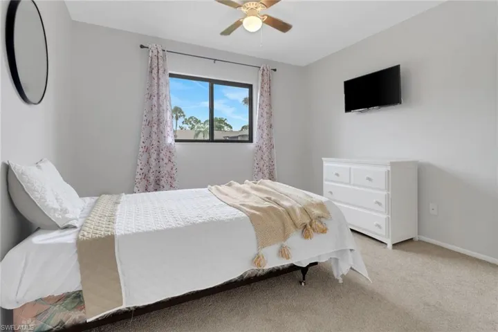 Carpeted bedroom with ceiling fan