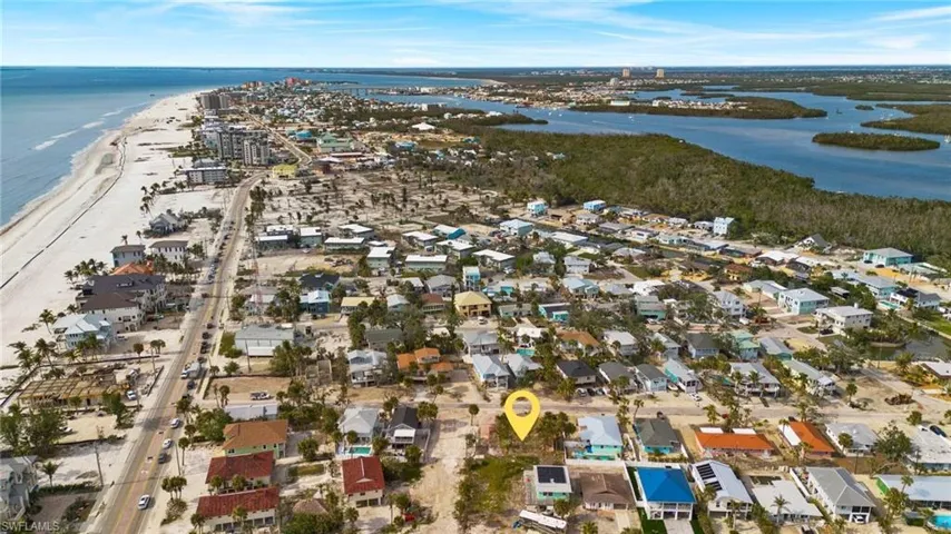 Aerial view featuring a beach view and a water view - Virtually Edited Image