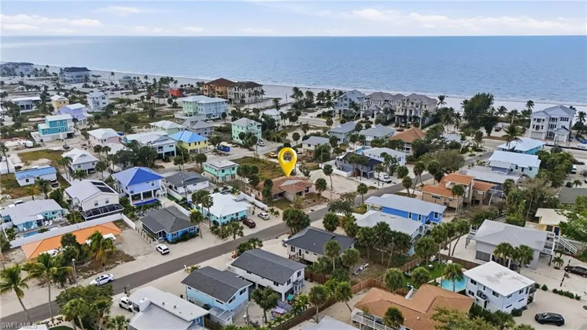 Aerial overview of property's location featuring a nearby body of water and nearby suburban area - Virtually Edited Image