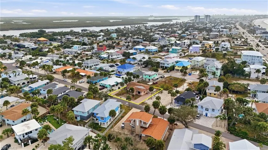 Aerial view of residential area featuring a large body of water - Virtually Edited Image