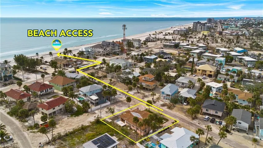 Aerial view of residential area featuring extended coastline and property boundaries highlighted - Virtually Edited Image