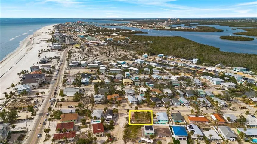 Aerial view featuring a beach view and a water view - Virtually Edited Image