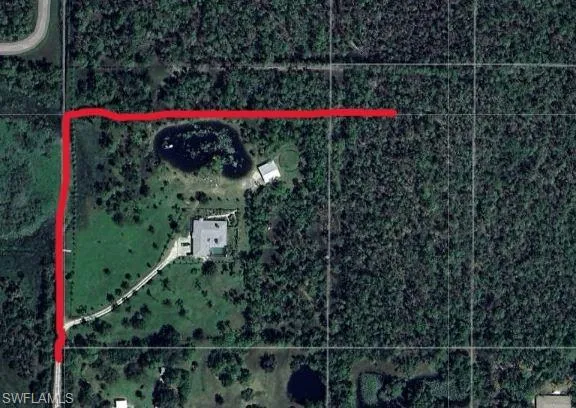 The easement (red line) reflects the legal ingress-egress.  The exisiting home has a fence and gate at the right turn.  Legal docs attached to the listing.