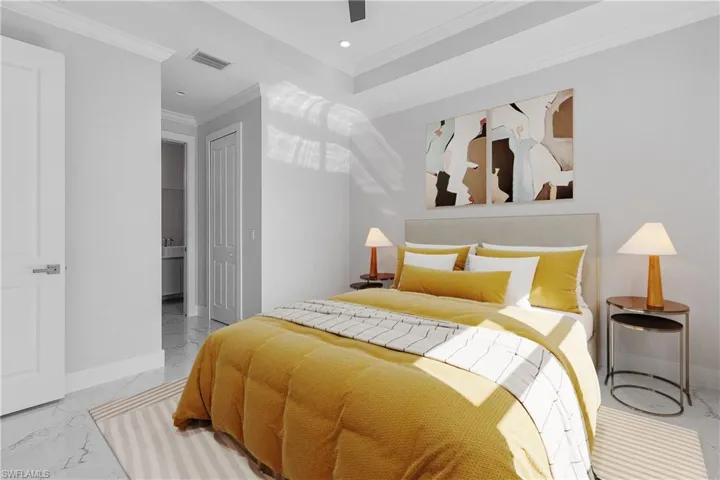 Bright room featuring high ceilings, crown molding, and recessed lighting
