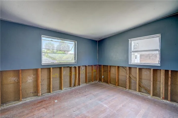 Empty room with vaulted ceiling