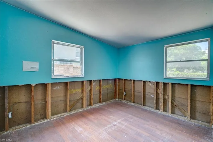 Spare room featuring wood-type flooring