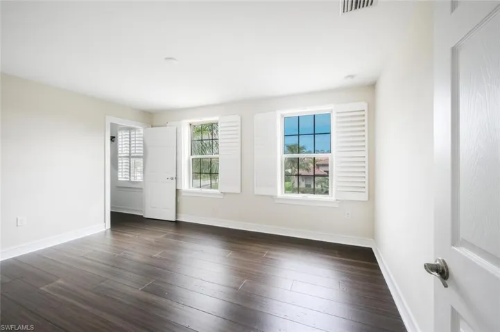 Spare room with dark hardwood / wood-style floors