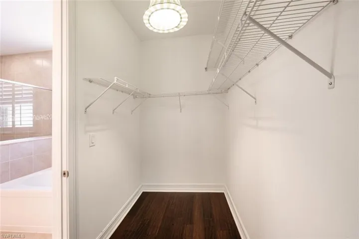 Spacious closet with hardwood / wood-style floors