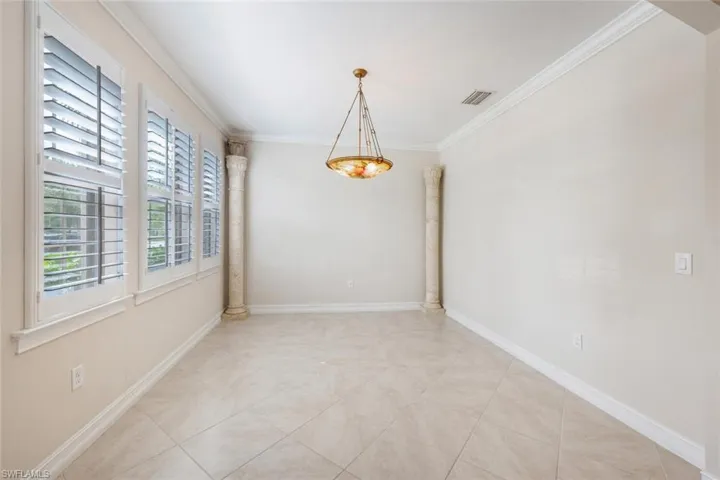 Unfurnished dining area featuring light tile patterned floors and crown molding