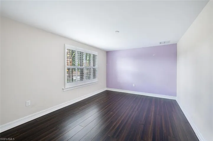 Spare room featuring dark hardwood / wood-style floors