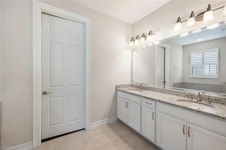 Bathroom featuring tile patterned flooring and vanity