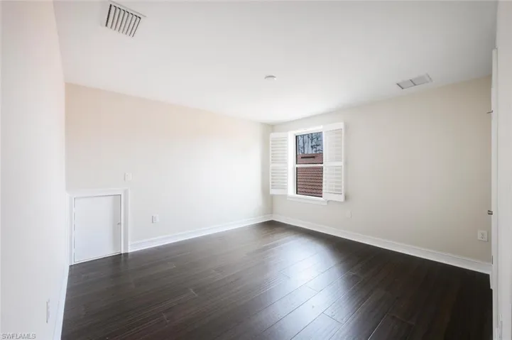 Unfurnished room with dark hardwood / wood-style flooring