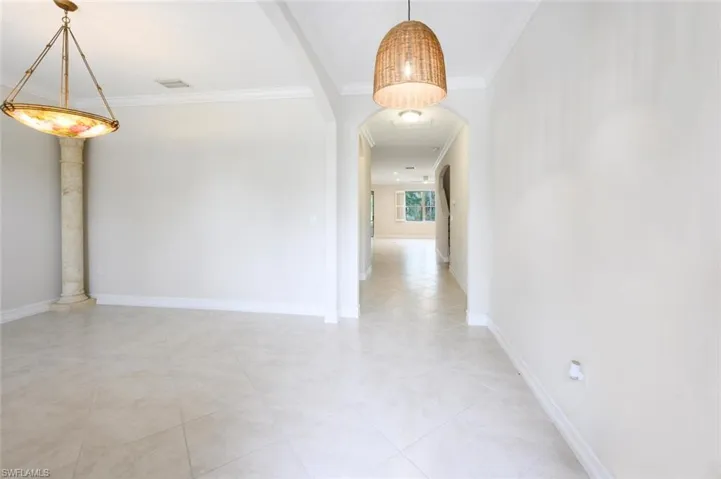 Hall with decorative columns and ornamental molding