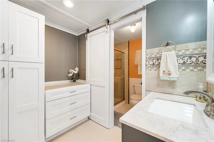 Full bathroom featuring a stall shower, vanity, and recessed lighting