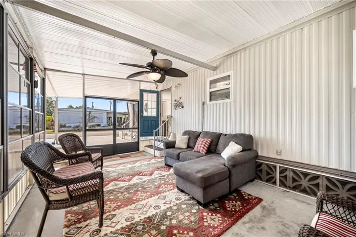 Sunroom / solarium featuring ceiling fan and an outdoor living space