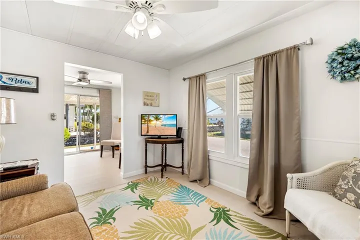 Living room with a ceiling fan and baseboards