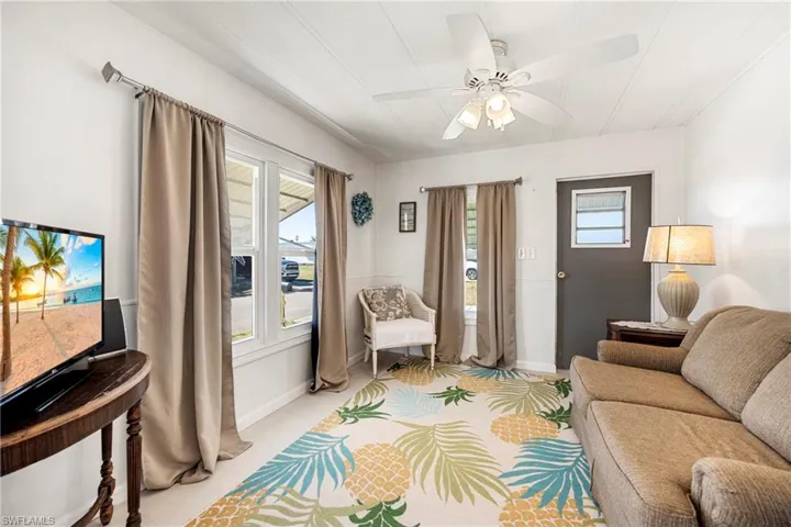 Living room featuring plenty of natural light and ceiling fan