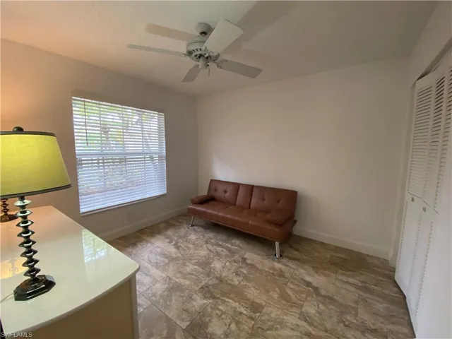 Sitting room with a textured ceiling and a ceiling fan