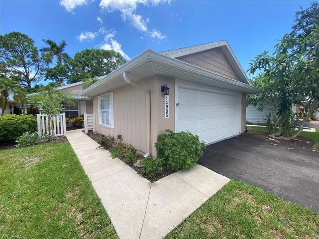 View of side of home with an attached garage and driveway