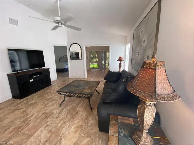 Living area featuring lofted ceiling and ceiling fan