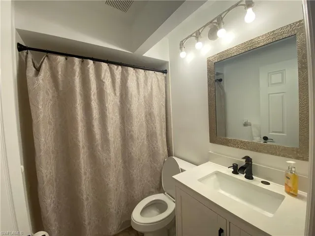 Full bath with vanity and a shower with curtain