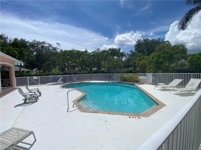 Community pool with a patio
