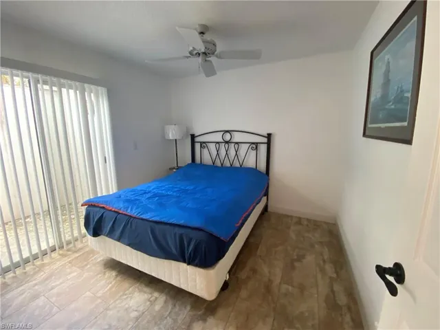 Bedroom with ceiling fan and baseboards