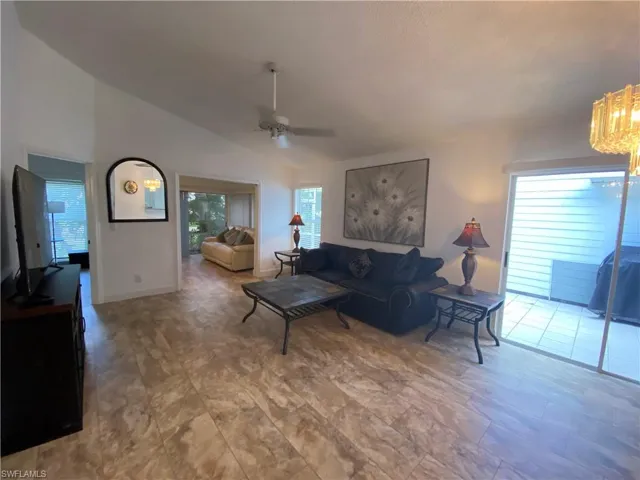 Living area featuring vaulted ceiling and a ceiling fan