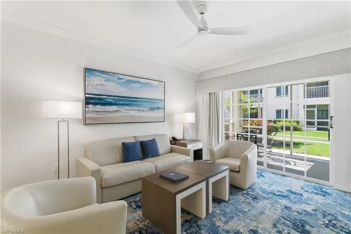 Living area featuring ornamental molding and ceiling fan