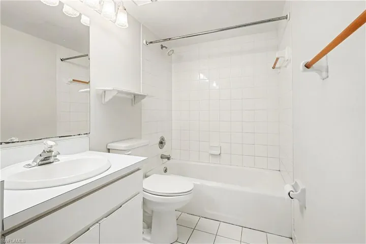 Bathroom with vanity, shower / washtub combination, and light tile patterned floors