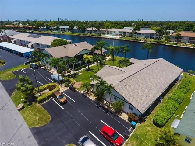 Aerial perspective of suburban area featuring a nearby body of water