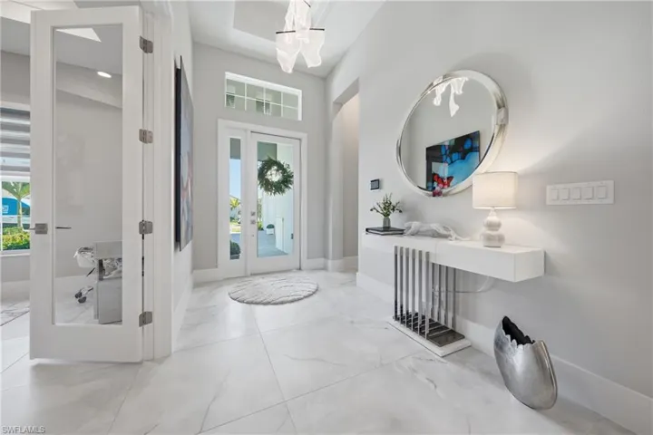 Welcoming foyer with elevated ceiling detail and clean architectural lines creating an immediate sense of scale.