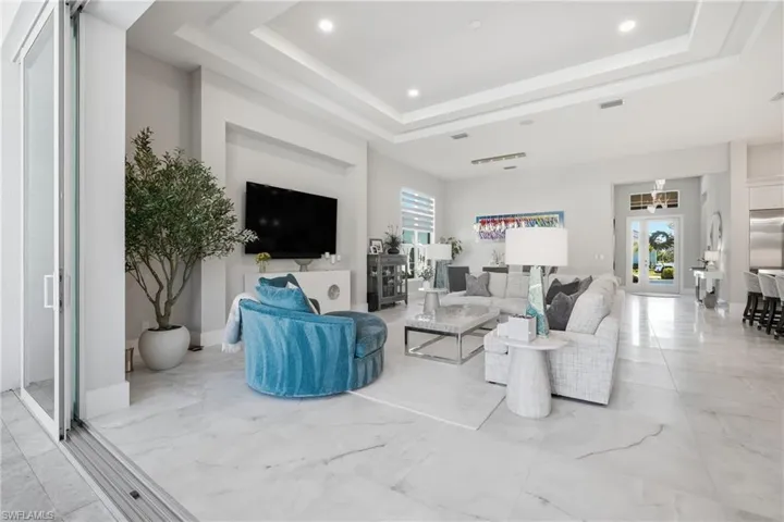 Open concept living area enhanced by upgraded lighting and a seamless indoor outdoor connection.