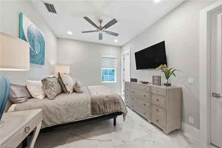 Generously sized guest bedroom with ample closet space and privacy, ideal for visiting family or long term stays.