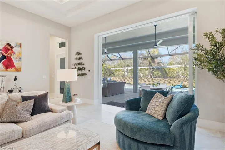 Light filled living space anchored by clean architectural lines and open flow into the kitchen and dining areas.