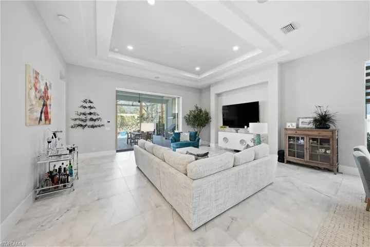 Light filled living space anchored by clean architectural lines and open flow into the kitchen and dining areas.
