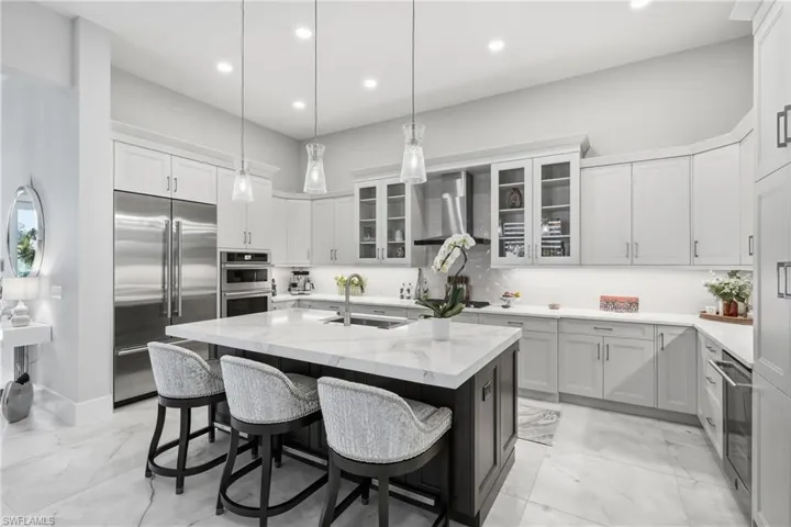 Expansive island kitchen offering seating for guests and effortless flow into the main living area.