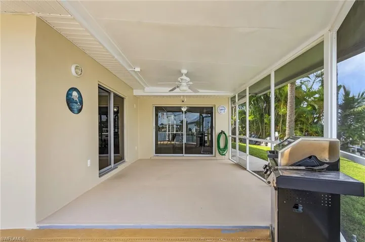 Unfurnished sunroom with plenty of natural light and ceiling fan