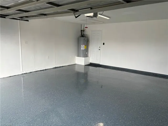 Garage with electric water heater and a garage door opener