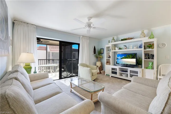 Comfortable Living Room seating with clear view out to Screened in and tiled Lanai...