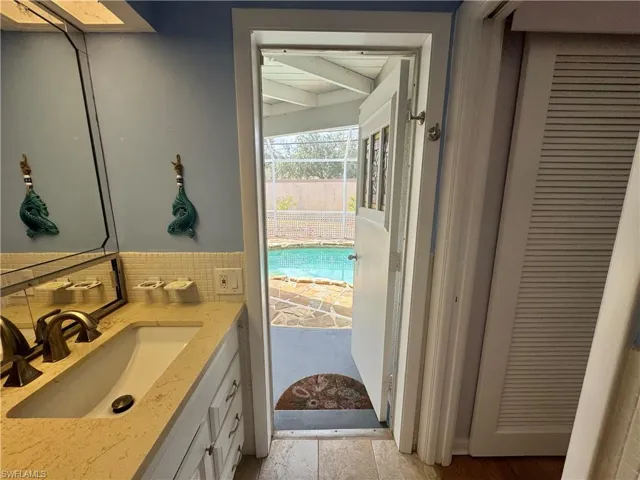 Bathroom featuring decorative backsplash and vanity